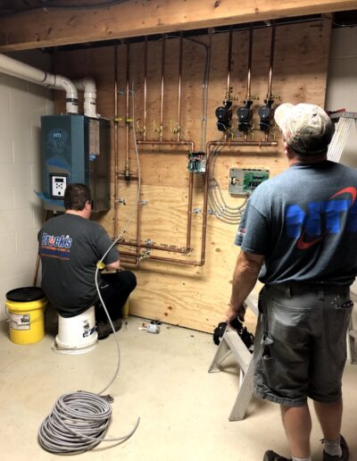 Techs installing heating system