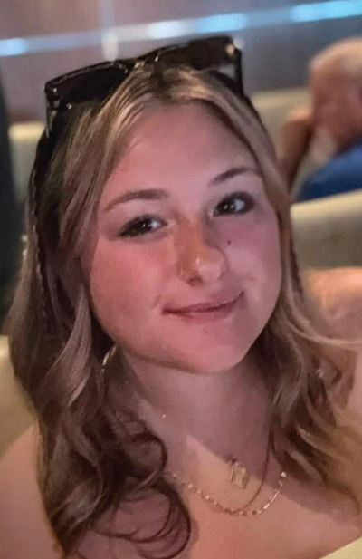 Head shot of Melanie Brock with sunglasses on her head