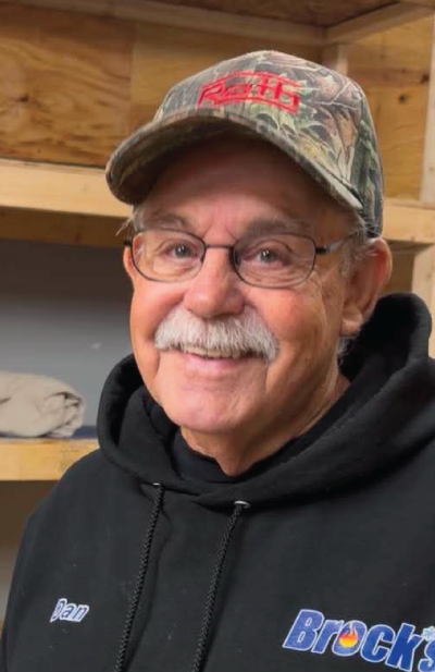 Dan Brock in a camo hat and black Brock's hoodie