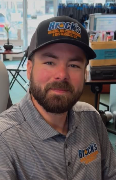 Stephen Farrow in a Black Brock's Hat and Gray Polo Shirt